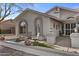 Inviting front exterior with stone accents, seating area, desert landscaping, and a charming, well-lit entryway at 9826 W Tonto Ln, Peoria, AZ 85382