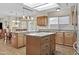 Bright eat-in kitchen features an island, breakfast bar, and plenty of wooden cabinets and countertops at 9826 W Tonto Ln, Peoria, AZ 85382