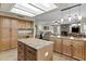 A wide-angle view of the open kitchen, including a breakfast bar and adjacent living area at 9826 W Tonto Ln, Peoria, AZ 85382