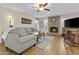 Cozy living room features a brick fireplace, ceiling fan, and access to a patio at 9826 W Tonto Ln, Peoria, AZ 85382