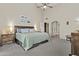 This is a large main bedroom featuring carpet, a ceiling fan, and ensuite bathroom at 9826 W Tonto Ln, Peoria, AZ 85382