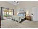 Spacious main bedroom with a ceiling fan and sliding glass doors to the screened lanai at 9826 W Tonto Ln, Peoria, AZ 85382