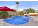 Refreshing backyard pool with lush landscaping, deck chairs, and pink flamingo floats, ideal for relaxation at 9826 W Tonto Ln, Peoria, AZ 85382