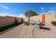 A cozy backyard seating area is nestled within a desert landscape and block wall at 10832 W Piute Ave, Peoria, AZ 85373