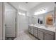 Bright bathroom featuring a double sink vanity, framed mirror, and tiled flooring at 10832 W Piute Ave, Peoria, AZ 85373