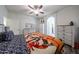 Comfortable bedroom featuring a ceiling fan, wood-look floors, and stylish furnishings at 10832 W Piute Ave, Peoria, AZ 85373
