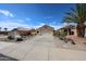 Charming home featuring a desert-style front yard with a palm tree and a spacious driveway at 10832 W Piute Ave, Peoria, AZ 85373