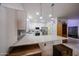 Well-lit kitchen featuring quartz countertops, stainless steel appliances, and tile flooring at 10832 W Piute Ave, Peoria, AZ 85373