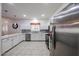 Well-lit kitchen featuring quartz countertops, stainless steel appliances, and tile flooring at 10832 W Piute Ave, Peoria, AZ 85373