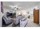 Open-concept living room with modern furnishings, neutral colors, and seamless flow to the kitchen at 10832 W Piute Ave, Peoria, AZ 85373