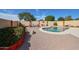 A beautiful backyard oasis with a pool, desert landscape, a seating area, and lush greenery at 10832 W Piute Ave, Peoria, AZ 85373
