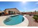 Backyard pool with patio seating, lush landscaping, a pebble border and a building exterior at 10832 W Piute Ave, Peoria, AZ 85373