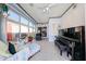Spacious sunroom with tiled floors, ample seating and a piano at 10832 W Piute Ave, Peoria, AZ 85373