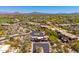 An aerial view showcases the gated entrance to this desert community, complete with mountain views in the background at 10901 E Quarry E Trl, Scottsdale, AZ 85262