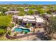 A breathtaking aerial view of the property's expansive pool and desert landscaping at 10901 E Quarry E Trl, Scottsdale, AZ 85262