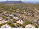 An aerial view of a desert community featuring single Gathering homes and a beautiful mountain range in the distance at 10901 E Quarry E Trl, Scottsdale, AZ 85262