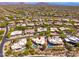 An aerial view of a desert community featuring single Gathering homes and a beautiful mountain range in the distance at 10901 E Quarry E Trl, Scottsdale, AZ 85262