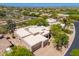 An aerial shot reveals a community amidst the desert landscape featuring spacious homes with desert landscaping at 10901 E Quarry E Trl, Scottsdale, AZ 85262
