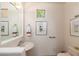 Powder room with framed pictures and wall mounted towel rack at 10901 E Quarry E Trl, Scottsdale, AZ 85262
