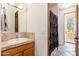 A bright bathroom showcasing a vanity with a tile countertop and a decorative shower curtain at 10901 E Quarry E Trl, Scottsdale, AZ 85262