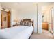 Bedroom features carpet, ceiling fan, and a view into the bathroom at 10901 E Quarry E Trl, Scottsdale, AZ 85262