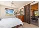 Bedroom features carpet, ceiling fan, and a sliding glass door to an outdoor space at 10901 E Quarry E Trl, Scottsdale, AZ 85262