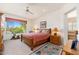 Cozy bedroom features a patterned rug, a window with desert views, and a ceiling fan at 10901 E Quarry E Trl, Scottsdale, AZ 85262
