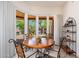 Cozy dining room with an oak table, backyard views, and access to the backyard at 10901 E Quarry E Trl, Scottsdale, AZ 85262