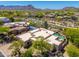 A sprawling desert home with an attached pool, lush landscaping, and mountain views at 10901 E Quarry E Trl, Scottsdale, AZ 85262