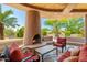 Cozy covered patio with a charming fireplace and comfortable seating area for outdoor relaxation at 10901 E Quarry E Trl, Scottsdale, AZ 85262
