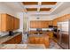 Spacious kitchen featuring granite countertops, wooden cabinets, and stainless steel appliances at 10901 E Quarry E Trl, Scottsdale, AZ 85262