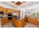 Updated kitchen with a granite island, stainless appliances, and wood beamed ceiling at 10901 E Quarry E Trl, Scottsdale, AZ 85262