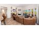 Cozy living room featuring a stone fireplace, comfortable seating, and access to the outdoor patio at 10901 E Quarry E Trl, Scottsdale, AZ 85262