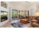 Bright living room with desert views from expansive windows and glass patio door at 10901 E Quarry E Trl, Scottsdale, AZ 85262