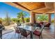 Expansive covered patio with a dining area and comfortable seating, ideal for enjoying outdoor living at 10901 E Quarry E Trl, Scottsdale, AZ 85262