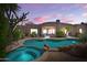 Inviting backyard featuring a private pool and spa, perfect for relaxation and entertaining under the evening sky at 10901 E Quarry E Trl, Scottsdale, AZ 85262