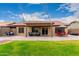 Relaxing backyard patio with seating area and manicured lawn at 11133 E Dragoon Ave, Mesa, AZ 85208