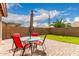 Charming patio with outdoor dining set and lush green lawn at 11133 E Dragoon Ave, Mesa, AZ 85208