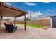 Inviting backyard featuring a covered patio and well-maintained lawn at 11133 E Dragoon Ave, Mesa, AZ 85208