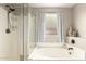 Bathroom features include a stand up shower, garden tub, and window with privacy at 11133 E Dragoon Ave, Mesa, AZ 85208