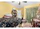 Cozy yellow bedroom with a decorative bed and a rattan shelf, plus a sitting area at 11133 E Dragoon Ave, Mesa, AZ 85208