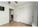 This is a bedroom with white closet doors and doorway into another room at 11133 E Dragoon Ave, Mesa, AZ 85208