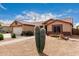 Single-story home featuring desert landscaping, two-car garage, and tiled roof, with brick walkway at 11133 E Dragoon Ave, Mesa, AZ 85208