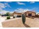 Single-story home featuring desert landscaping, two-car garage, and tiled roof, with brick walkway at 11133 E Dragoon Ave, Mesa, AZ 85208