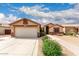Charming single-story home featuring a two-car garage, desert landscaping, and a tiled roof at 11133 E Dragoon Ave, Mesa, AZ 85208