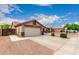 Charming single-story home featuring a two-car garage, desert landscaping, and a tiled roof at 11133 E Dragoon Ave, Mesa, AZ 85208