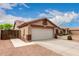 Charming single-story home featuring a two-car garage, desert landscaping, and a tiled roof at 11133 E Dragoon Ave, Mesa, AZ 85208