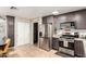 Kitchen boasts gray cabinets, stainless steel appliances, and tile floors, creating a modern, functional space at 11133 E Dragoon Ave, Mesa, AZ 85208