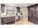 A kitchen sink features gray cabinets, stainless steel appliances, and granite countertops at 11133 E Dragoon Ave, Mesa, AZ 85208