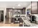 The kitchen features gray cabinets, stainless steel appliances, granite countertops, and tile backsplash at 11133 E Dragoon Ave, Mesa, AZ 85208